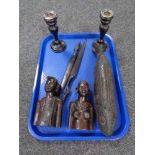 A tray of pair of ebony candlesticks with silver mounts, carved wooden fish box, two tribal busts,