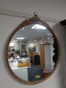 A circular decorative brass mirror