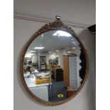 A circular decorative brass mirror