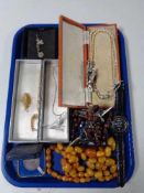 A tray of costume jewellery, beaded necklaces, crucifix, wrist watches,