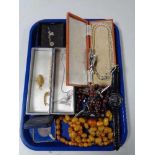 A tray of costume jewellery, beaded necklaces, crucifix, wrist watches,