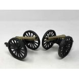 A pair of brass and metal cannons