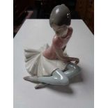 A Lladro figure - seated Ballerina