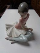 A Lladro figure - seated Ballerina