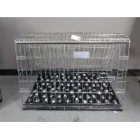 A folding black metal dog cage, height 67 cm, width 86 cm, depth 56 cm.
