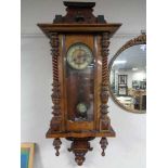 An early twentieth century mahogany cased eight day wall clock with brass and enamelled dial