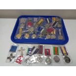 A tray of reproduction British war medals on ribbons