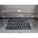 A folding black metal dog cage, height 67 cm, width 86 cm, depth 56 cm.