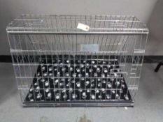 A folding black metal dog cage, height 67 cm, width 86 cm, depth 56 cm.