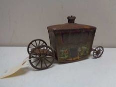 An antique Jacobs biscuit tin in the form of a state carriage