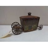 An antique Jacobs biscuit tin in the form of a state carriage