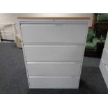 A four drawer metal document cabinet with oak effect top with key