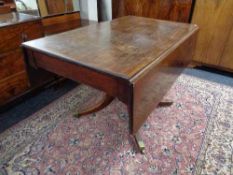 A Victorian mahogany flap sided pedestal dining table