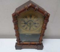 A late nineteenth century German pine cased fifteen day mantel clock