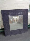 A mosaic framed wall mirror