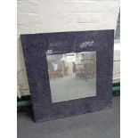 A mosaic framed wall mirror