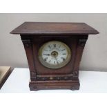 An Edwardian oak cased mantel clock with silvered and enamelled dial by Fattorini and Sons,