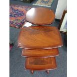 An inlaid mahogany nest of three tables together with pedestal wine table