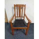 An Edwardian oak carver armchair