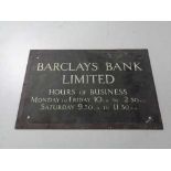 A brass Barclays bank limited business hours plaque