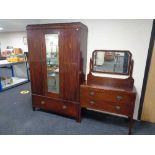 An Edwardian inlaid mahogany mirrored wardrobe fitted with a drawer and a two drawer dressing chest