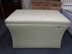 A storage ottoman containing electric rise and fall tv mount