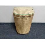 A golden Lloyd loom linen basket