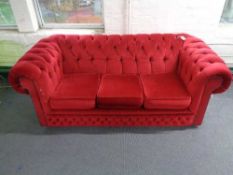 A Chesterfield club three seater settee in red dralon