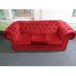 A Chesterfield club three seater settee in red dralon