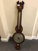 An early 19th century inlaid mahogany barometer with silvered dial