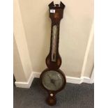 An early 19th century inlaid mahogany barometer with silvered dial