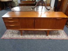 A mid century teak low sideboard. Height 73 cm x length 183 cm x depth 44 cm.