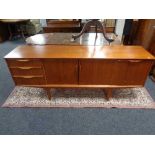 A mid century teak low sideboard. Height 73 cm x length 183 cm x depth 44 cm.