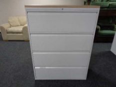 A four drawer metal document cabinet with oak effect top with key