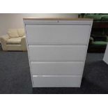 A four drawer metal document cabinet with oak effect top with key