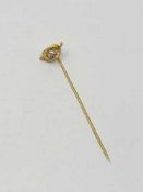 A high carat gold pin set with a good quality diamond approximately 0.25ct, 1.8g.