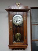 An Edwardian oak Arts and Crafts wall clock with silvered dial CONDITION REPORT: 85