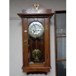 An Edwardian oak Arts and Crafts wall clock with silvered dial CONDITION REPORT: 85
