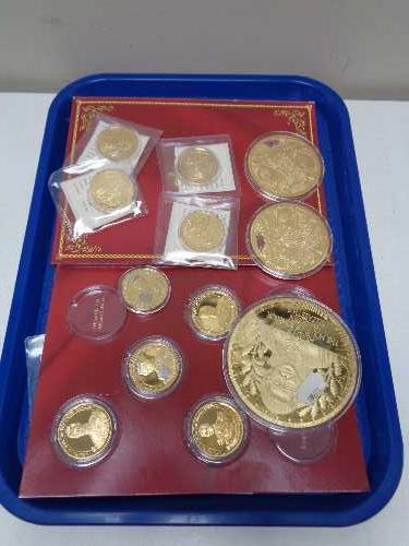 A tray of twelve gold plated commemorative coins,