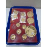 A tray of twelve gold plated commemorative coins,