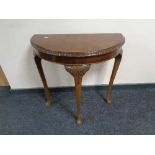 A walnut Queen Anne style D-shaped table