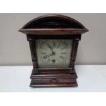An early twentieth century HAC stained pine eight day mantel clock with silvered dial