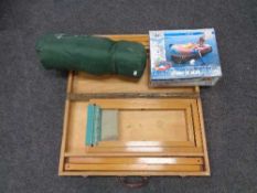 A portable folding picnic table set together with an inflatable dinghy and mattress etc