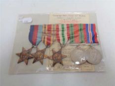 A set of five WW II medals on ribbons