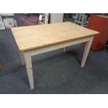 A reclaimed pine kitchen table on painted legs. 77 cm x 127 cm x 80 cm.