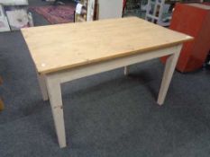 A reclaimed pine kitchen table on painted legs. 77 cm x 127 cm x 80 cm.