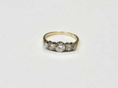 An 18ct gold five stone diamond ring, the principal stone weighing 0.
