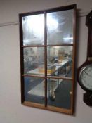 A teak twentieth century sectional mirror