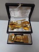 Two sets of gold plated tea spoons,