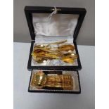 Two sets of gold plated tea spoons,